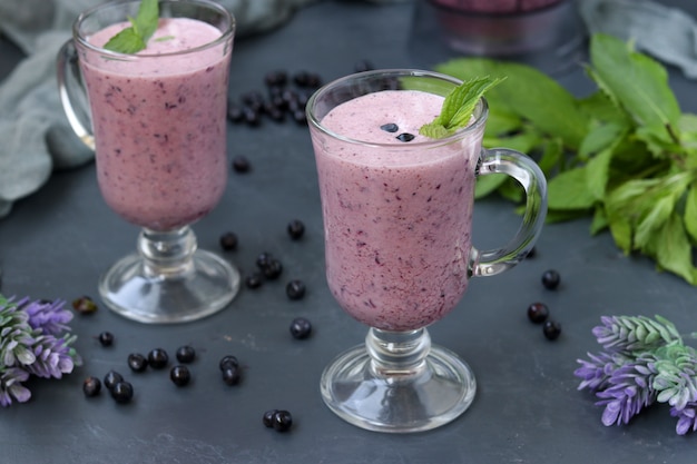 Nutritious cocktail with yogurt and blueberries located in glasses 