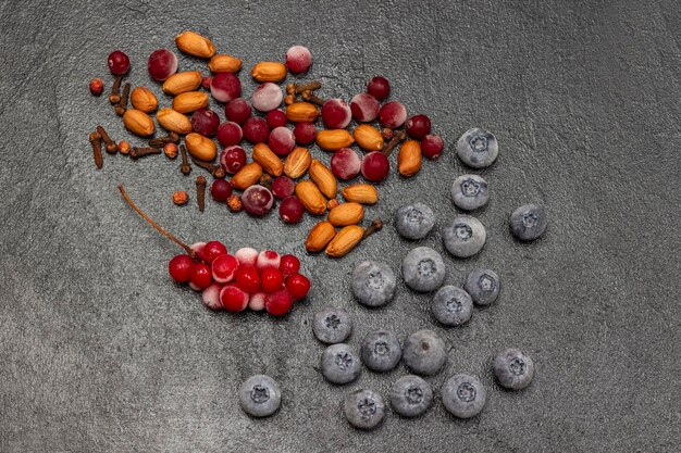 Nuts cloves frozen blueberries and bunches of red berries