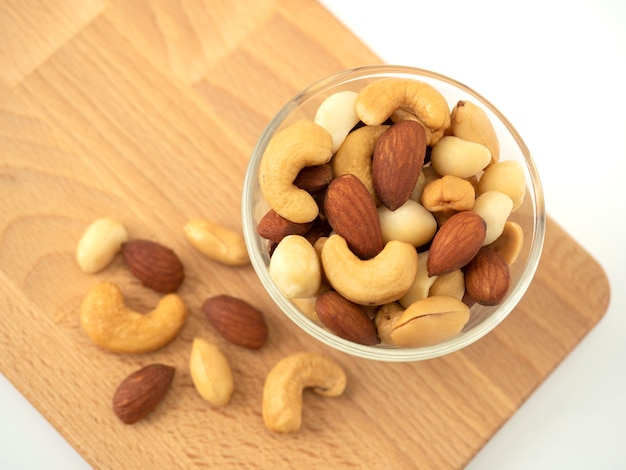 Nuts in glass bowls on cutting board.