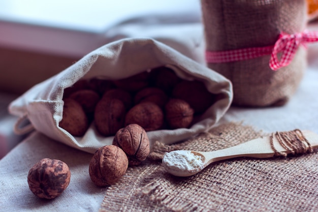 Nuts in a sack  and a spoon with flour