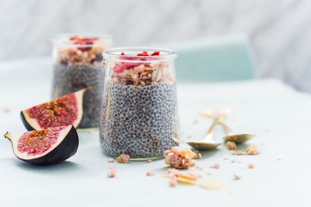 Nuts topping on chia's smoothie in transparent jar