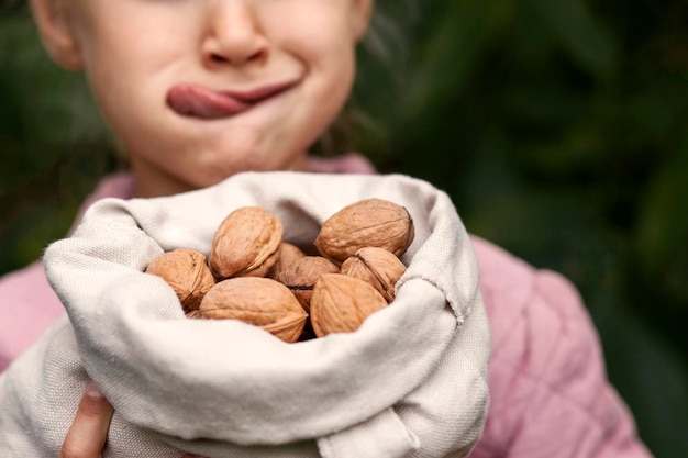 Nuts Walnut for Child with Tongue out. Walnuts Harvest. Organic Food for Children. Copt space.