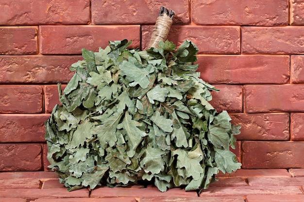 Oak broom for a bath on a stone surface.