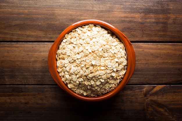 Oat flakes, uncooked oats in bowl, Concept of healthy eating, vegan food, healthy food, breakfast.