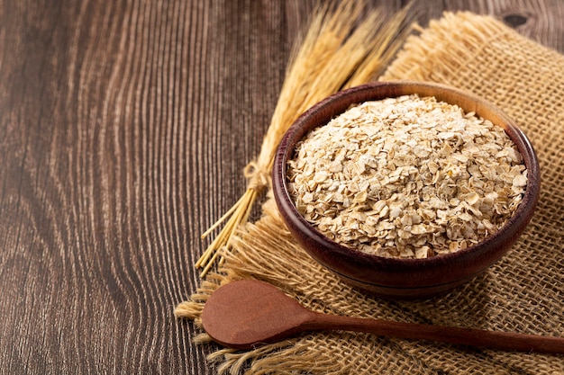 Oat flakes in wooden bowl