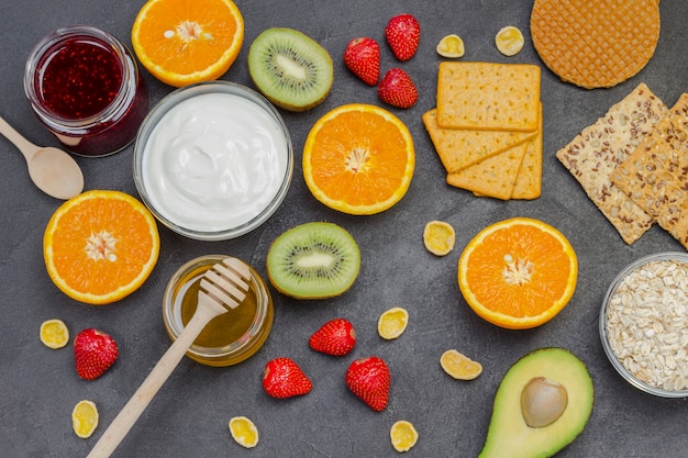 Oatmeal, avocado berries, fruits, jam, yogurt for Energy Healthy breakfast