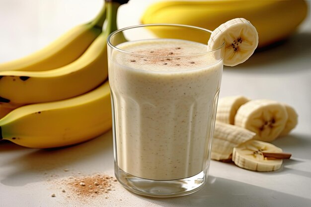 An oatmeal and banana smoothie for breakfast is set down on a white concrete floor foods to consume ...