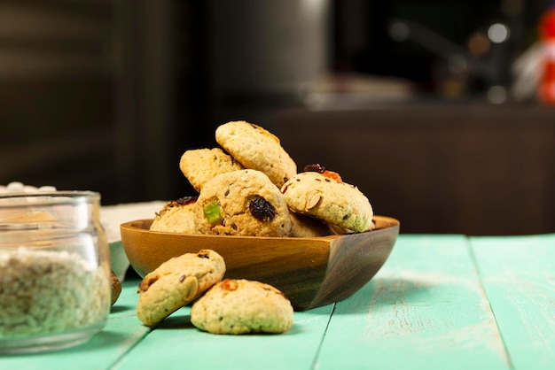 Oatmeal cookies with candied fruits in a wooden plate