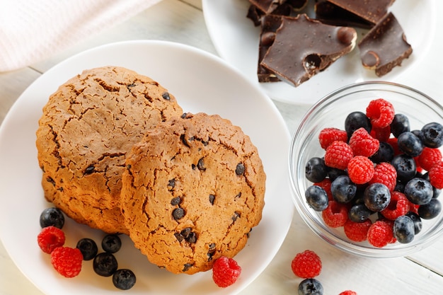 Oatmeal cookies with chocolate and berries on white Oatmeal cookies with chocolate