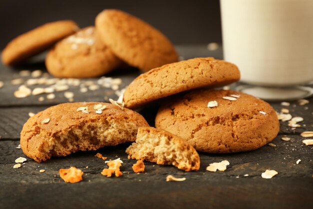 Oatmeal cookies with milk on wooden table