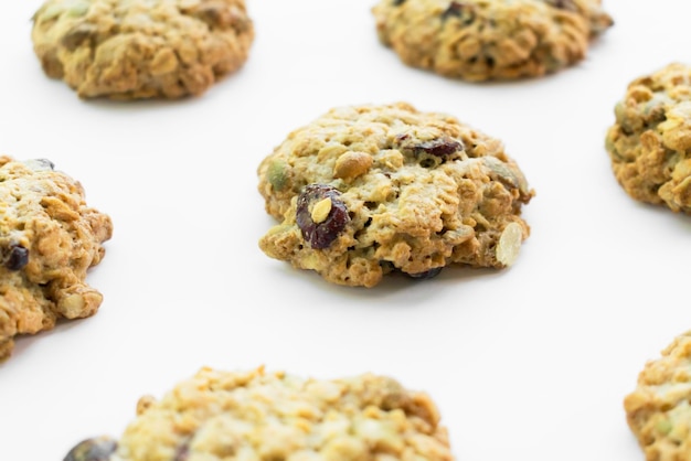 oatmeal cookies with nuts and cranberries on white background