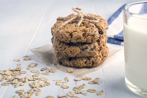 oatmeal cookies with raisins and chocolate. glass of  milk