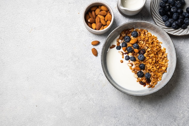 Oatmeal Granola with blueberry. Dry Breakfast. Healthy food or diet concept. Copy space. Granola with greek yogurt. Berry granola with almond. Top view. Food flatlay