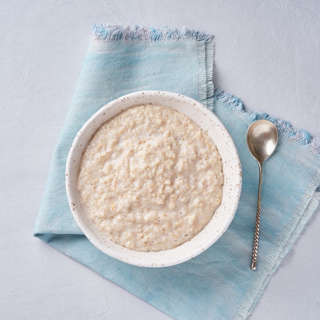 Oatmeal, healthy porridge in large bowl for breakfast.