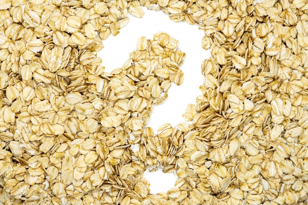 Oatmeal, question mark, macro, isolated, close up, top view. Popular healthy breakfast food. 