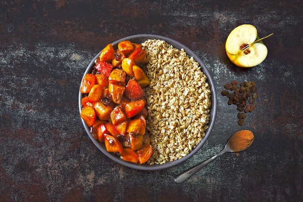 Oatmeal with apples and cinnamon. Breakfast bowl with oatmeal and apples.