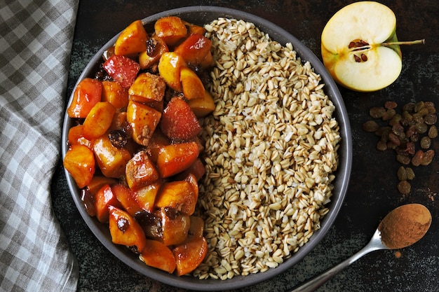 Oatmeal with apples and cinnamon. Breakfast bowl with oatmeal and apples.