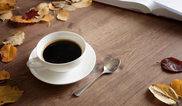 Objects on a wooden table a cup of coffee