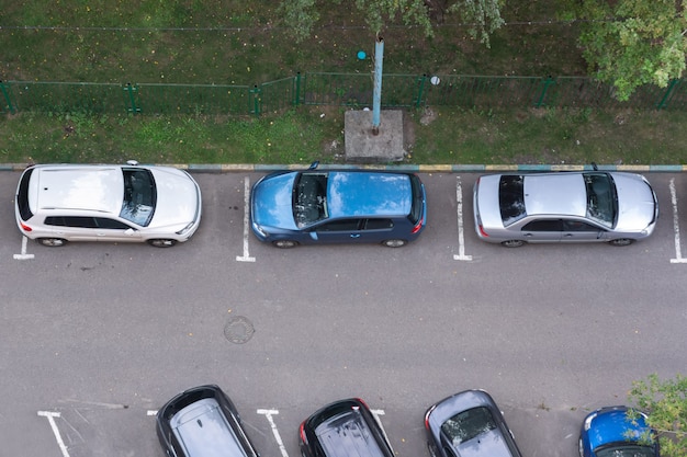 Occupied parking spaces near a residential high-rise building