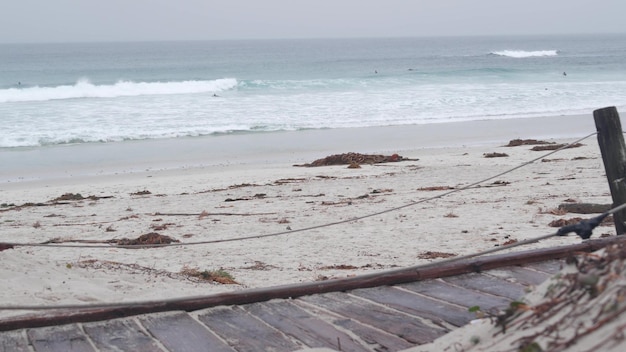 Ocean beach sandy dunes california misty coast foggy rainy weather cold sea