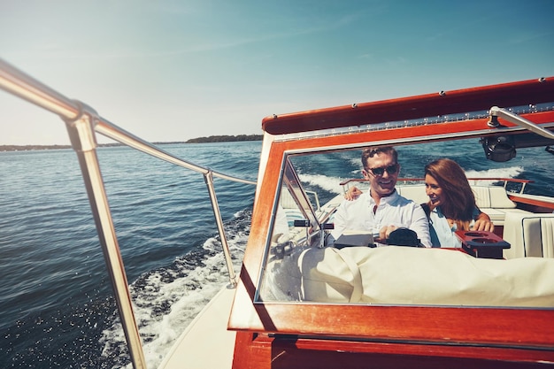 Ocean boat and couple in portrait for adventure driving and vacation journey in Sweden Happy people husband and wife in lake for honeymoon romantic and sailing for bonding in yacht outdoor