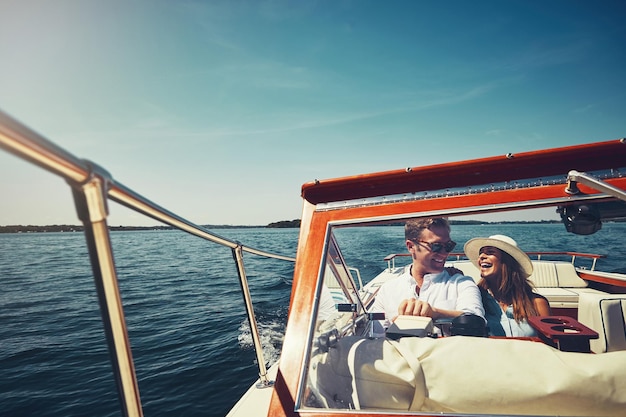 Ocean boat and couple with man for driving adventure and vacation journey in Sweden Happy people husband and wife in lake for honeymoon romantic and sailing for bonding together in yacht outdoor