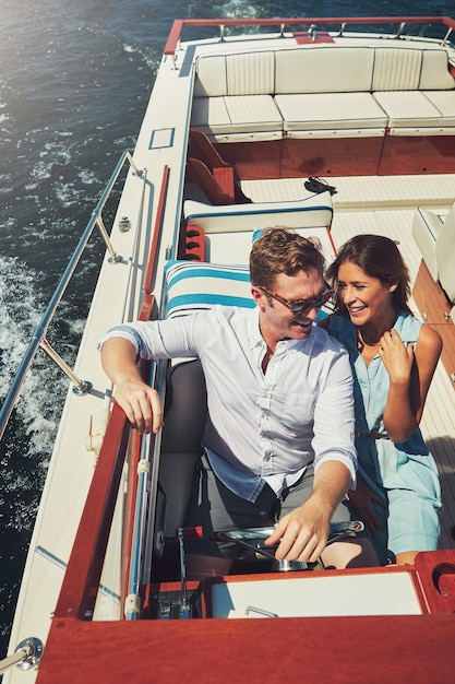 Ocean boat and happy couple with love for driving adventure and vacation journey in Sweden People husband and wife in lake for honeymoon romantic and sailing for bonding in yacht by high angle