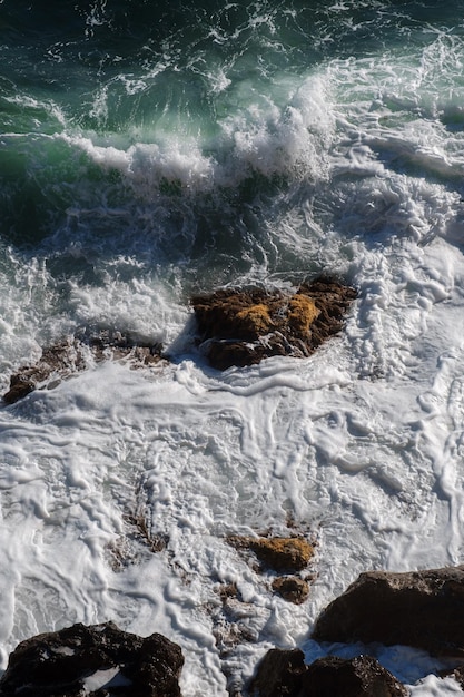 Ocean wave background breaking sea water rocky shore