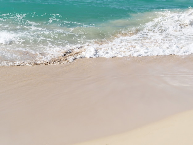 Ocean wave and white sand at tropical beach, Dominican Republic.