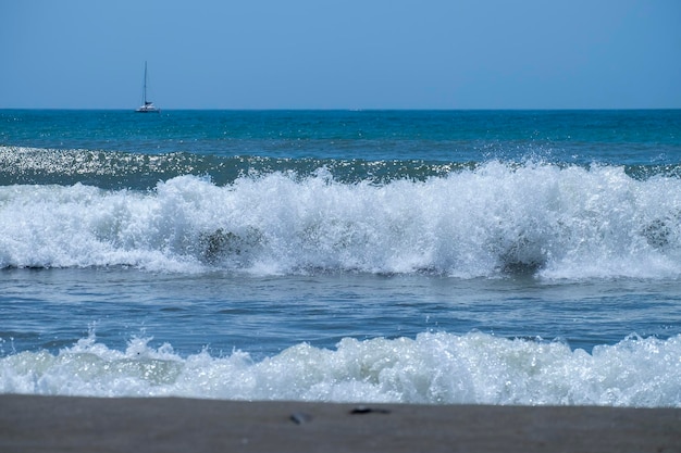 Ocean waves crashing on sandy beach Sea waves breaking on Maditerranean's shore