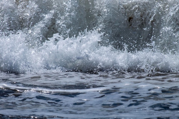 Ocean waves crashing on sandy beach Sea waves breaking on shore