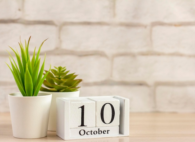 October 10 on a wooden calendar on a table or shelfOne day of the autumn monthCalendar for October Autumn