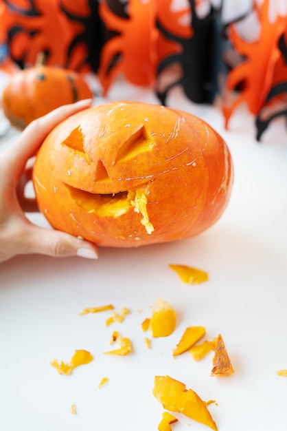 October 31 Halloween holiday The carved face of a pumpkin on an orange and black background