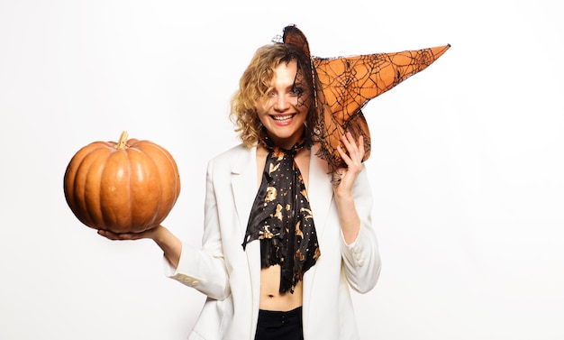 Photo october halloween party smiling woman in witch hat with pumpkin preparation halloween holidays sexy