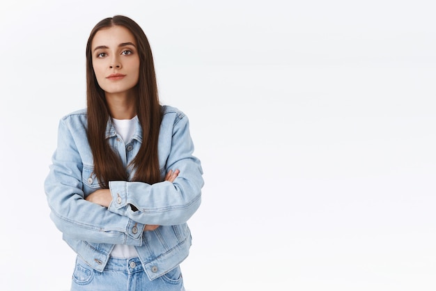 Offended seriouslooking sulking brunette girl cross hands over chest look arrogant and snobbish standing insulted with upset bothered expression posing annoyed over white background