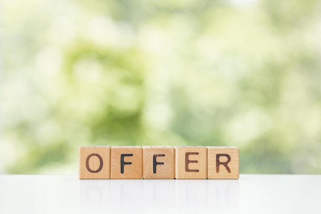 Offer Word In Wooden Cubes on a green background