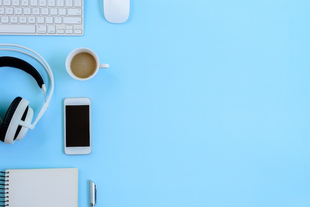 The office blue desk and equipment for working in top view and flat lay on blue background