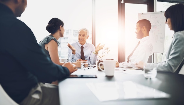 Photo office conversation and business people in meeting feedback and planning with discussion for funding report accounting broker or employees with ideas review finances and trading with lens flare