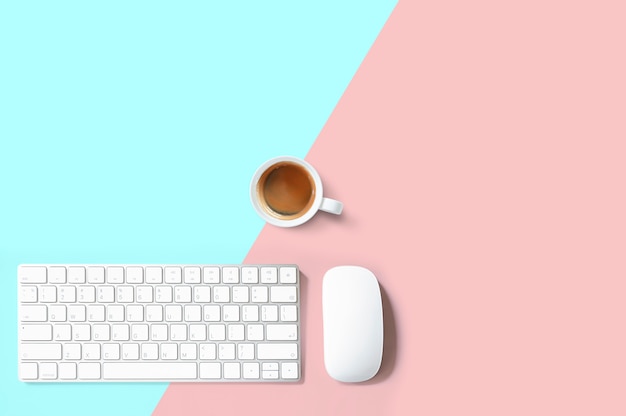 Office desk concept design with white keyboard, mouse and cup of coffee.