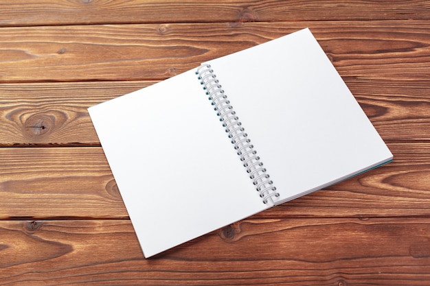 Office desk table top view, Notepad with blank pages on wooden table