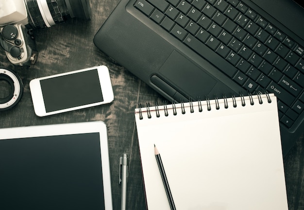 Office desk table with computer, supplies and tablet, mobile phone. 