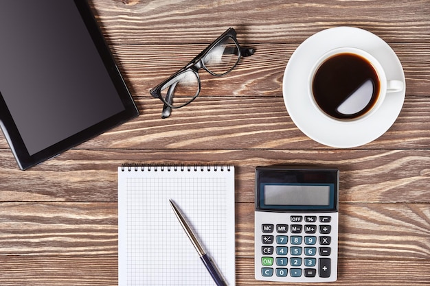 Office desk table with digital tablet and coffee cup