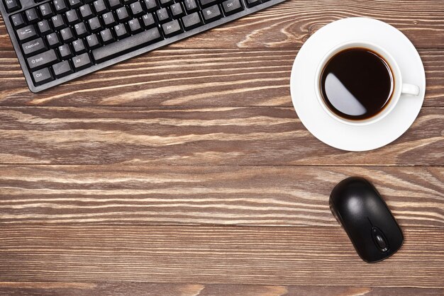 Office desk table with keyboard and coffee cup