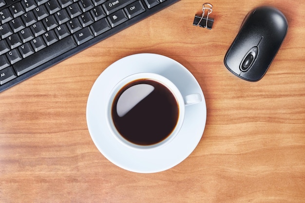 Office desk table with keyboard and coffee cup