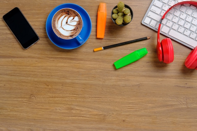 Office desk table with keyboard cup pencil headphones