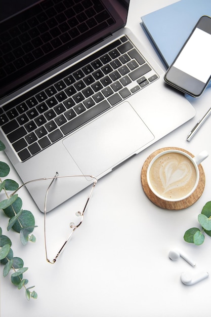 Office desk table with laptop supplies and coffee cup