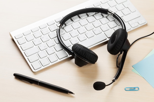 Office desk with headset and keyboard