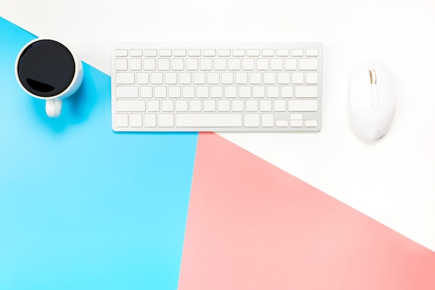 Office desk with keyboard, mouse and coffee