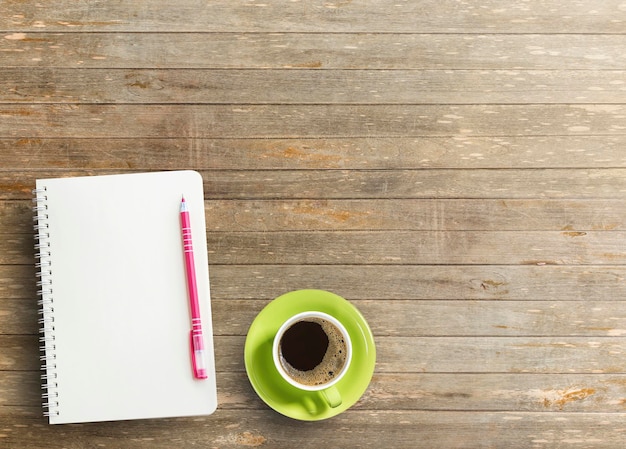 Office desk with notebook and coffee