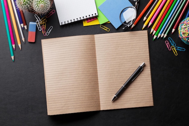 Office desk with notepad and supplies